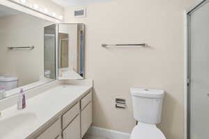 Bathroom with vanity and a shower with shower door