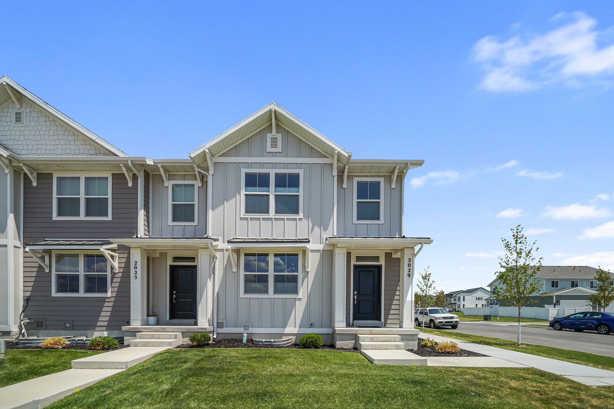 View of front of home featuring a front yard, board and batten siding, and a residential view