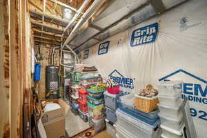 Unfinished below grade area featuring strapped water heater