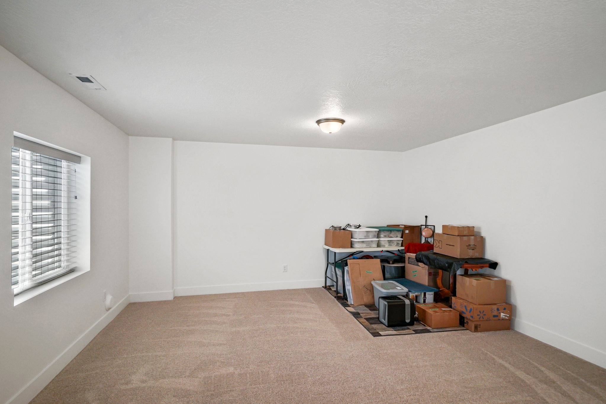 Unfurnished room featuring carpet and baseboards