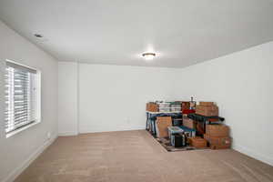 Unfurnished room featuring carpet and baseboards