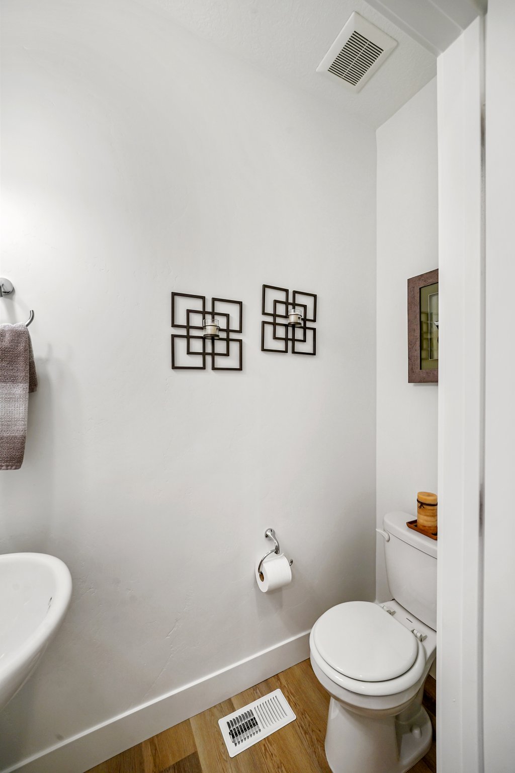 Bathroom with toilet and light wood-type flooring