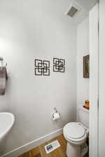 Bathroom with toilet and light wood-type flooring