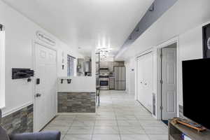 Living room with wainscoting and a textured ceiling