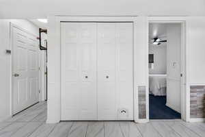 Unfurnished bedroom featuring light marble finish flooring and a closet
