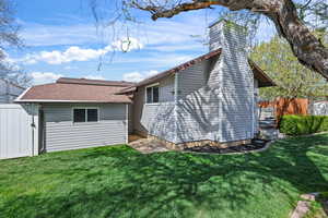 Rear view of property with roof with shingles and a chimney