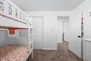 Bedroom with dark colored carpet