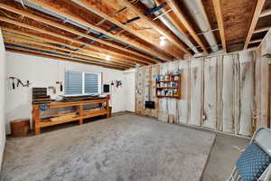 Unfinished basement featuring a workshop area