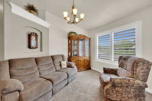 Living area with suspended lighting and light carpet