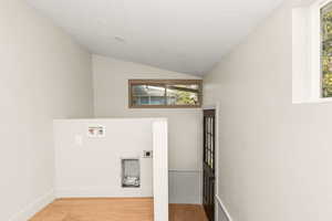 Laundry area off of the back the home with so much natural light and ambiance.