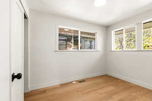 Bedroom with tons of natural light and wood floors