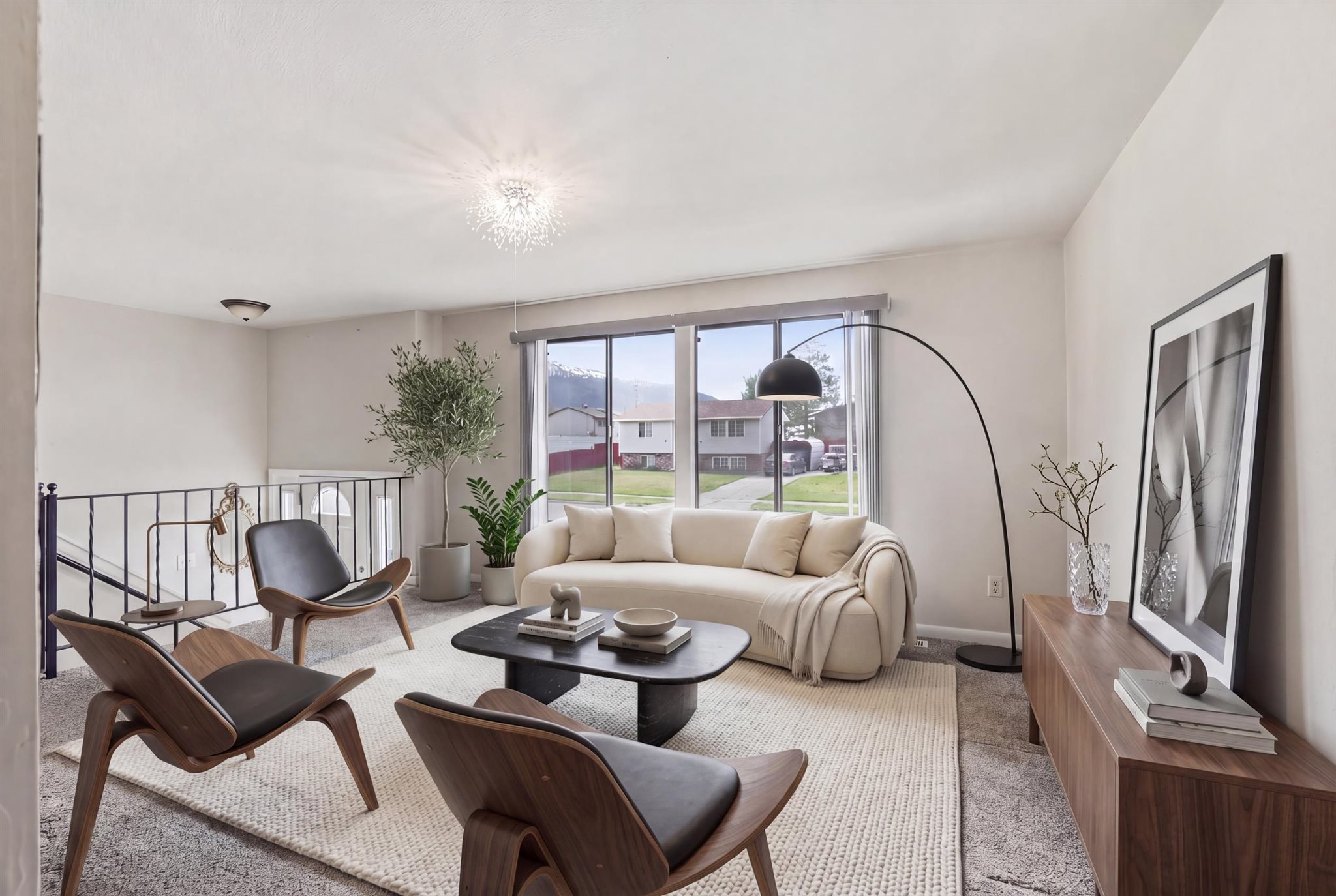 Living area with light colored carpet and a residential view