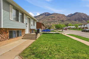 View of green lawn with a mountain view and a residential view