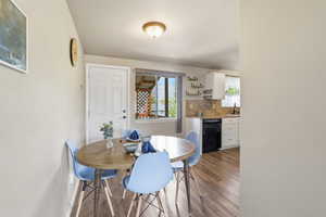 Dining room with dark wood finished floors and baseboards