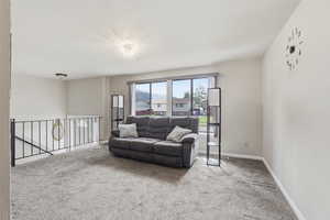 Living room with light carpet and baseboards