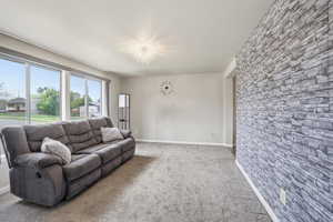 Living area featuring carpet and hanging lights