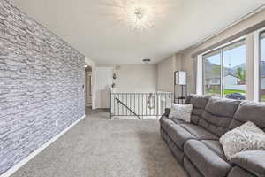 Living room featuring a mountain view, carpet floors, and an accent wall