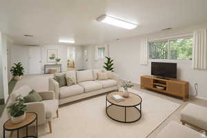Carpeted living room with healthy amount of natural light