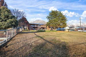 View of yard featuring a deck with mountain view