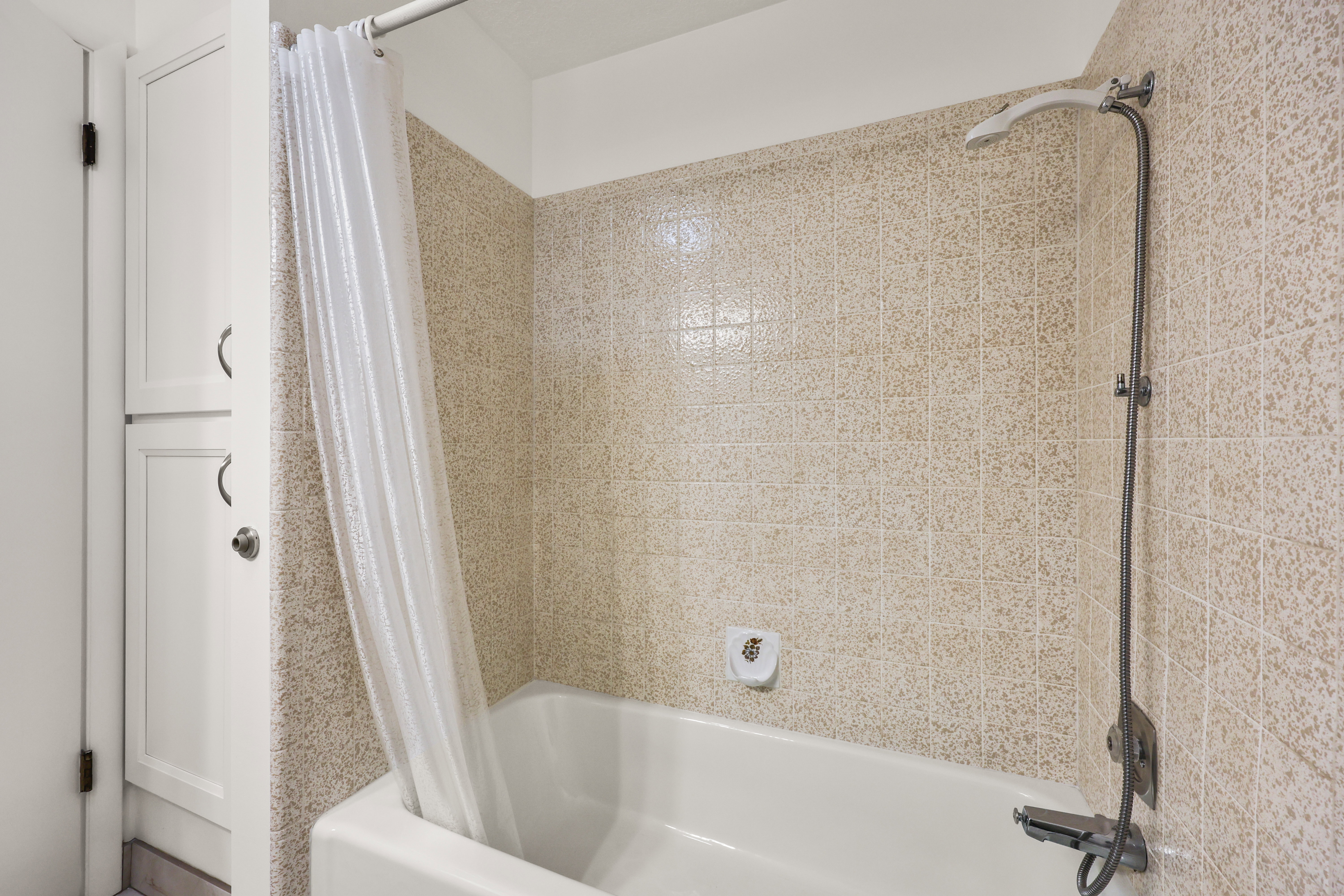 Bathroom featuring shower / bath combination with curtain