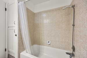 Bathroom featuring shower / bath combination with curtain