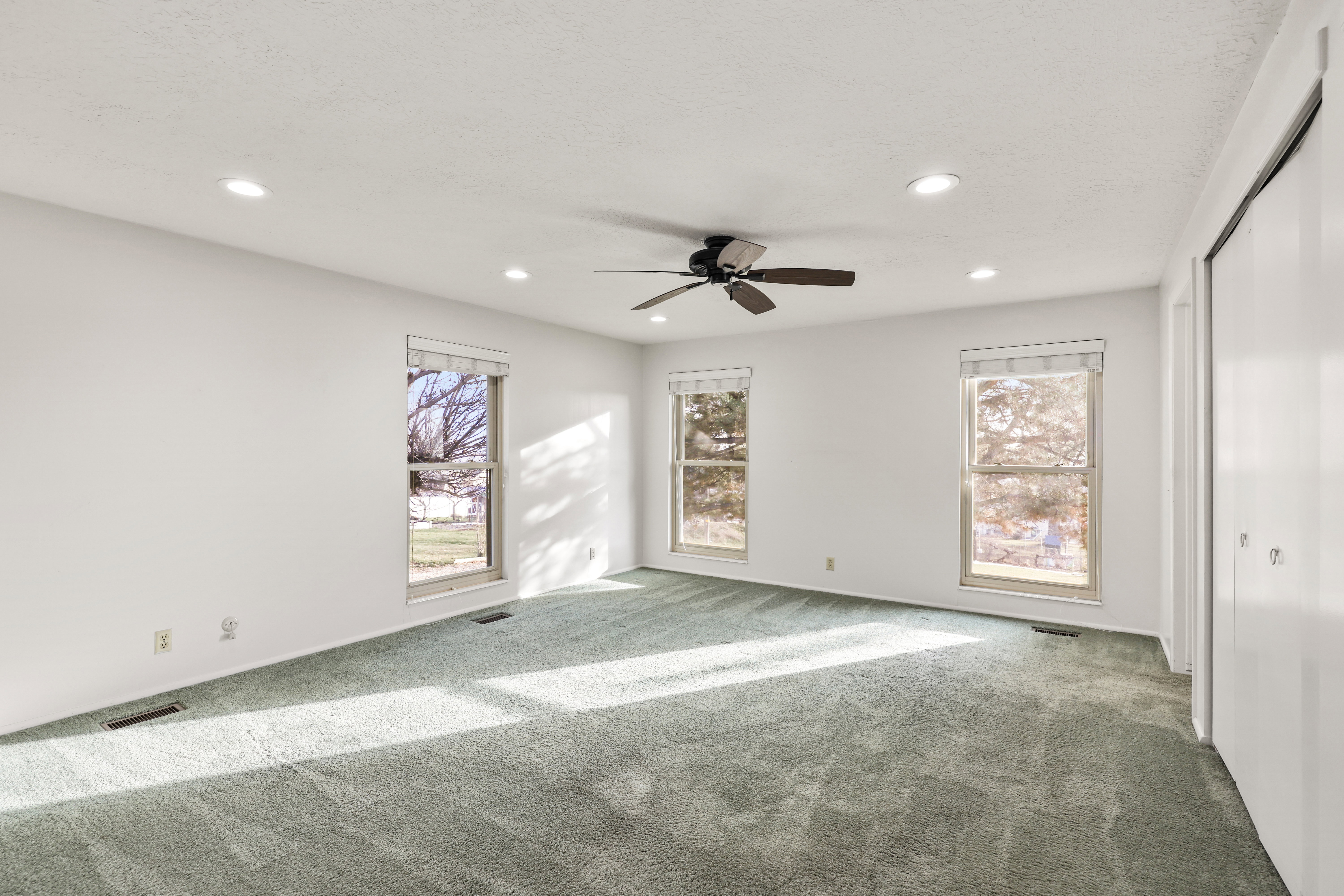 Unfurnished bedroom featuring carpet floors, a ceiling fan, and recessed lighting