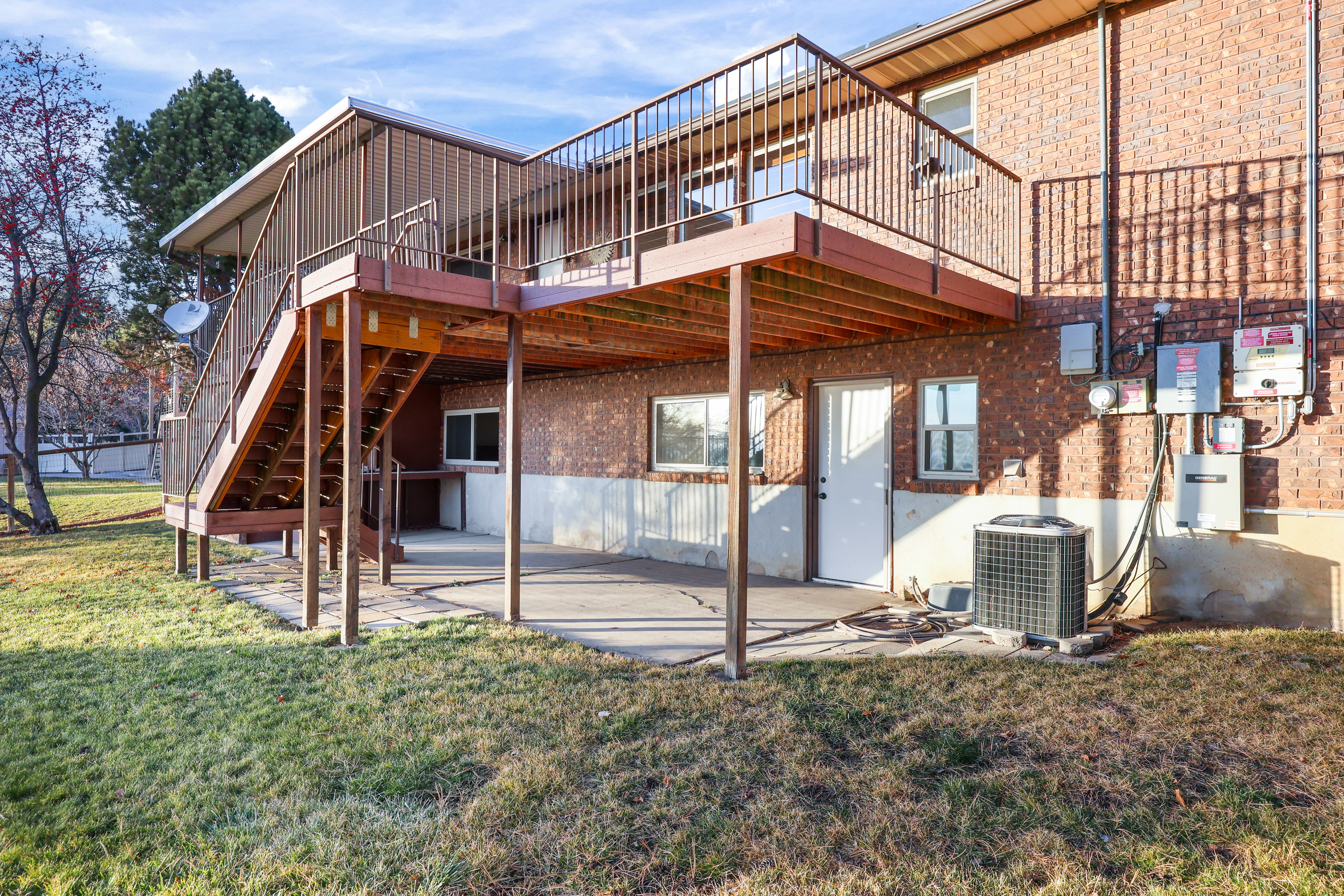 Back of house with a patio area, a lawn, and a deck