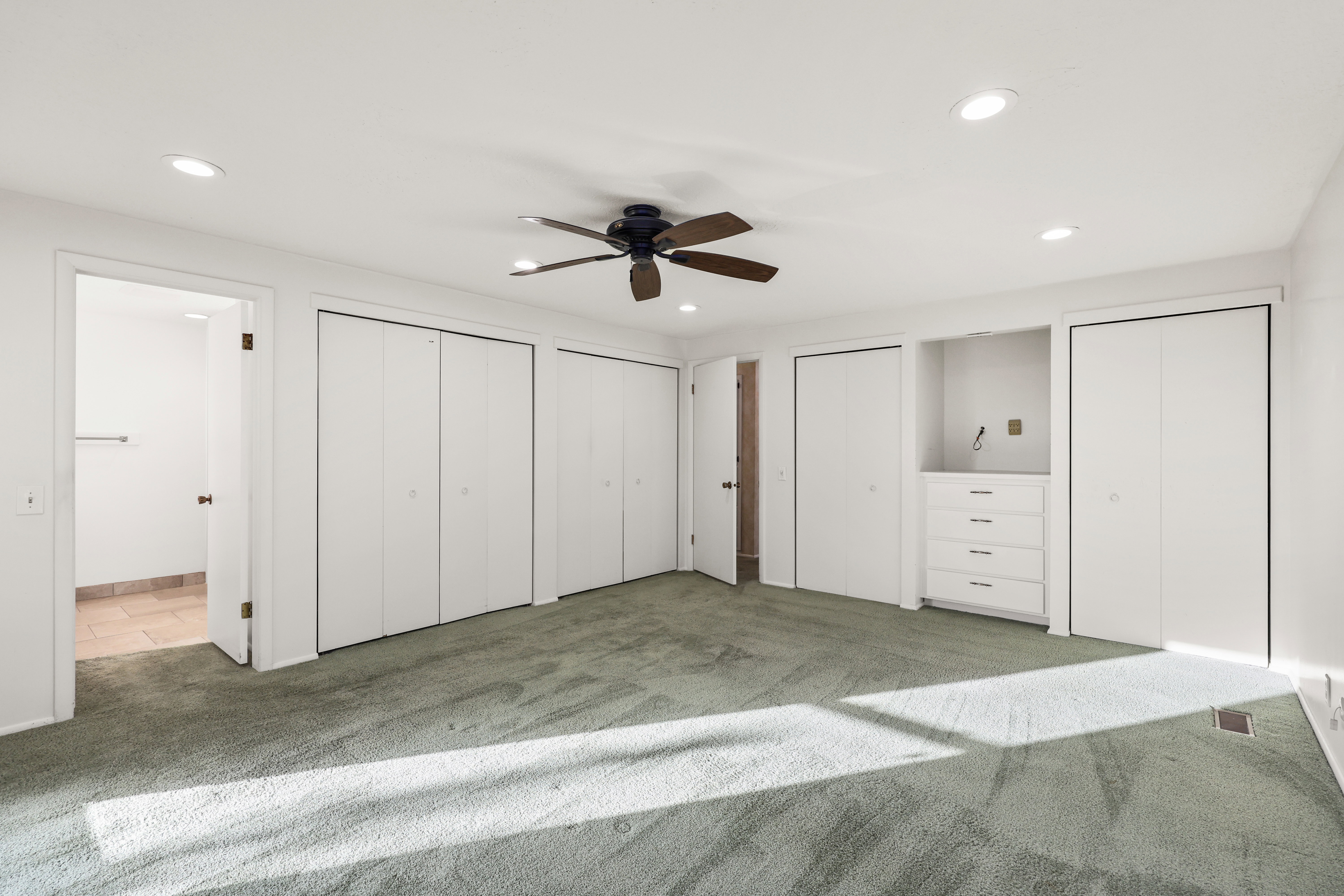 Unfurnished bedroom with multiple closets, carpet, a ceiling fan, and recessed lighting