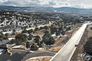 Aerial overview of property's location featuring a mountainous background