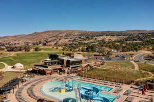 Bird's eye view of a mountainous background and a golf course