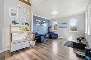 Sitting room featuring hardwood / wood-style floors and ornamental molding