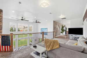 Carpeted living area featuring recessed lighting