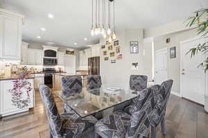 Dining space featuring dark wood finished floors and recessed lighting