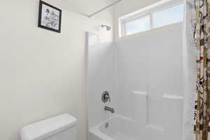 Bathroom with toilet and shower / tub combo