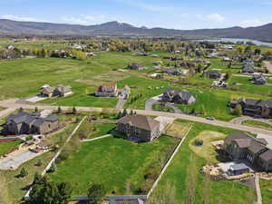 Aerial view of property's location with a mountainous background and nearby suburban area