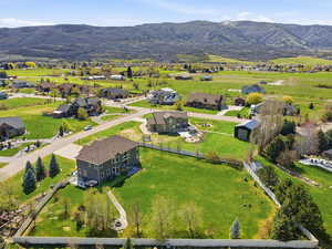 Aerial view of property's location featuring mountains and nearby suburban area