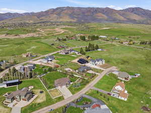 Aerial overview of property's location with nearby suburban area and a mountainous background