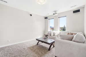 Living area featuring carpet flooring and baseboards