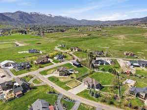 Aerial overview of property's location featuring nearby suburban area and a mountain backdrop