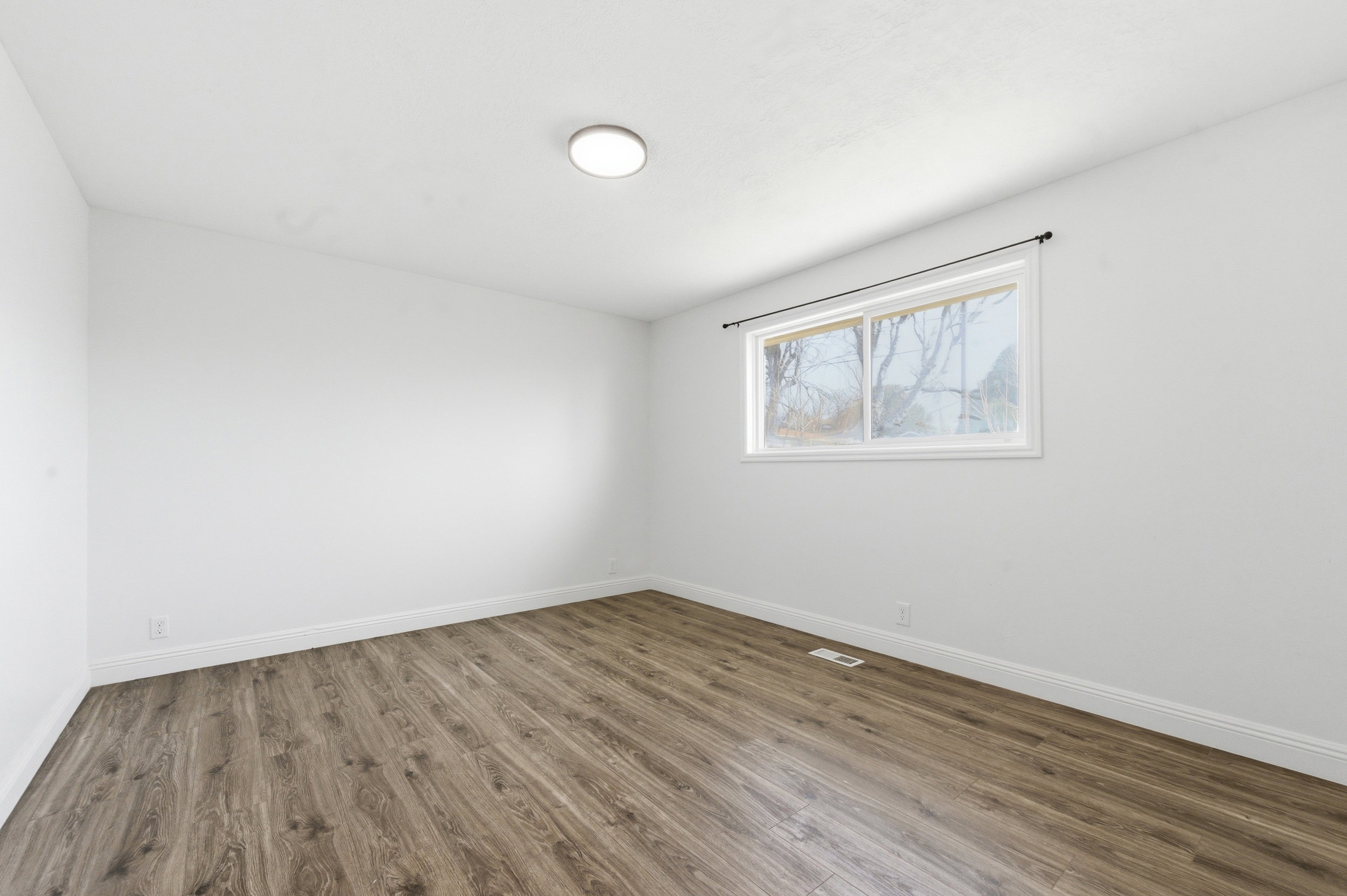 Empty room with wood finished floors and baseboards