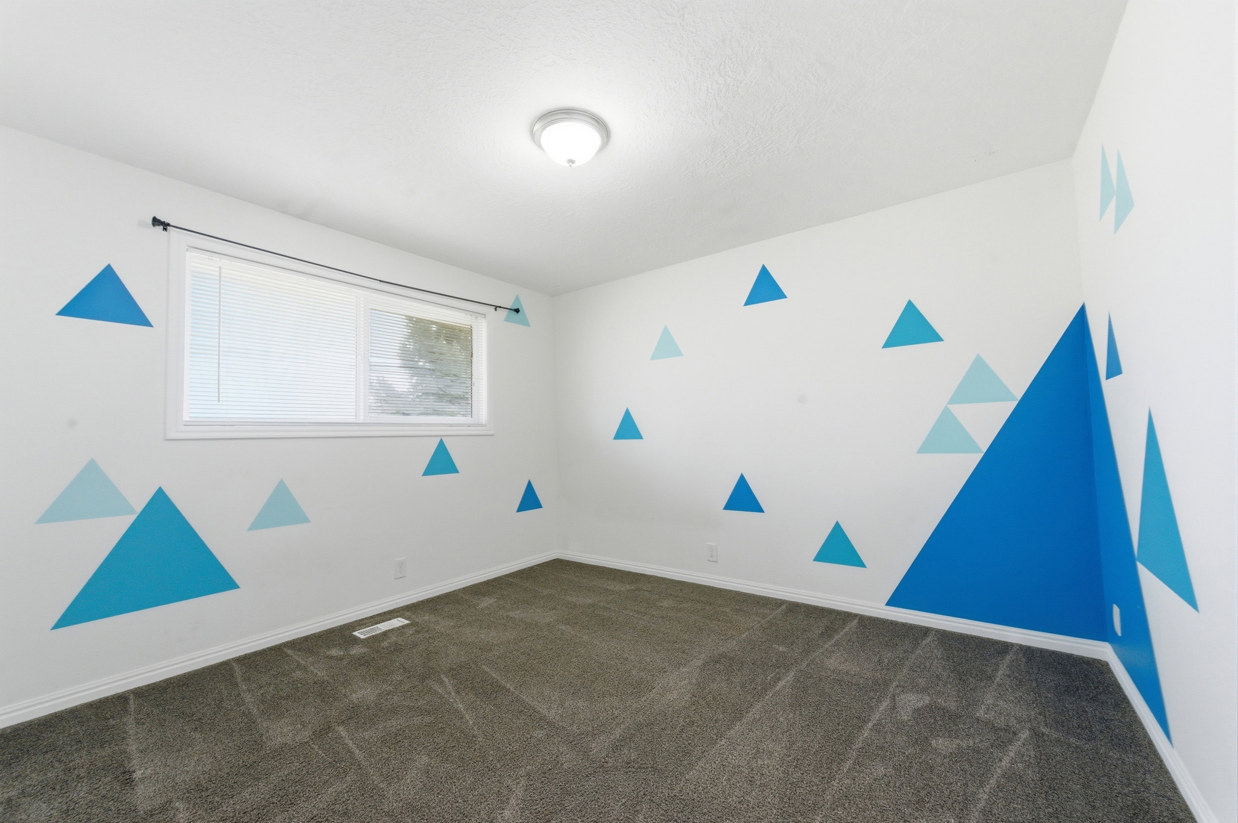 Empty room with dark carpet and baseboards