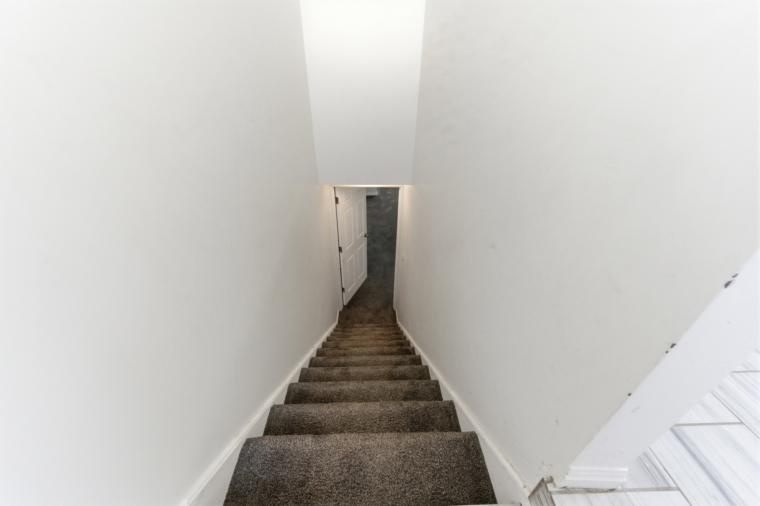 Staircase featuring baseboards