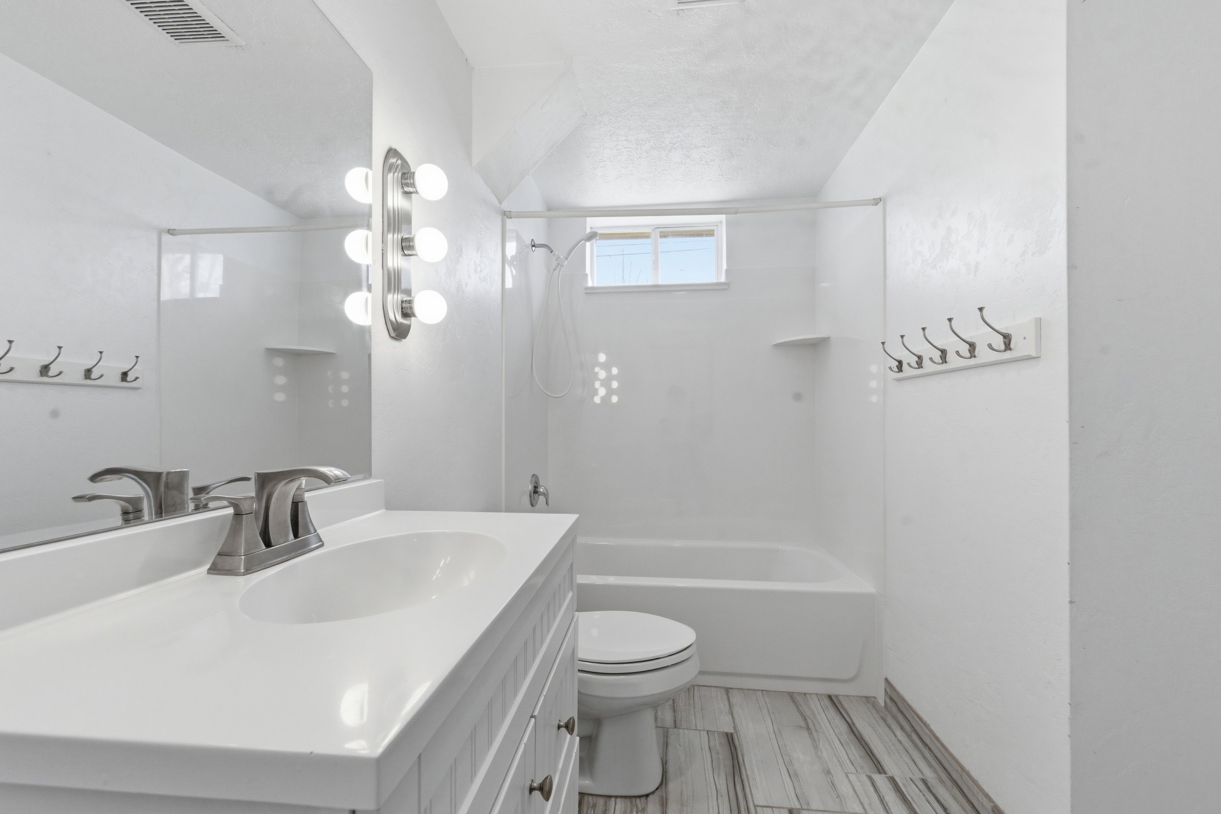Full bath featuring vanity, shower / tub combination, and lofted ceiling