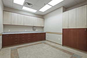 Kitchen with a drop ceiling and light countertops