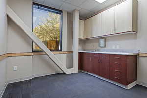 Bar area featuring light countertops, dark carpet, and a paneled ceiling
