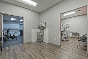 Home office with a drop ceiling and a wall unit AC