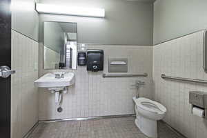 Bathroom featuring tile walls and wainscoting