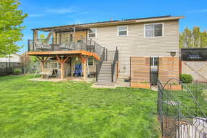 Back of house featuring a fenced backyard, a patio area, a gate, and a deck