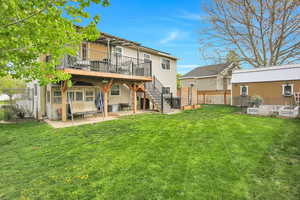 Back of property with a patio area, a fenced backyard, a deck, and an outdoor structure