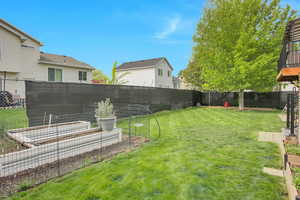 Fenced backyard with a garden and a residential view